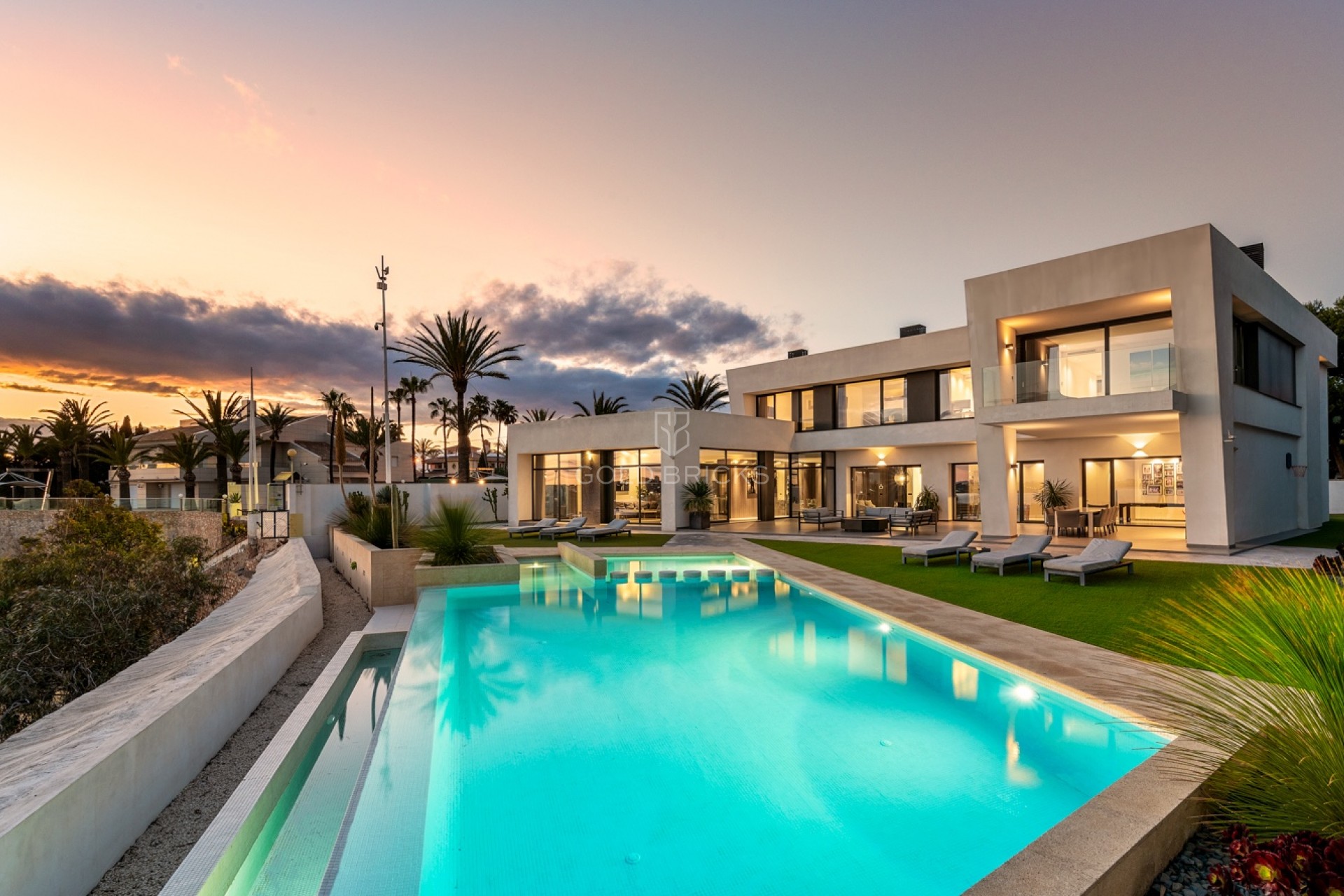 Villa exclusiva de Cabo Roig al atardecer con piscina iluminada